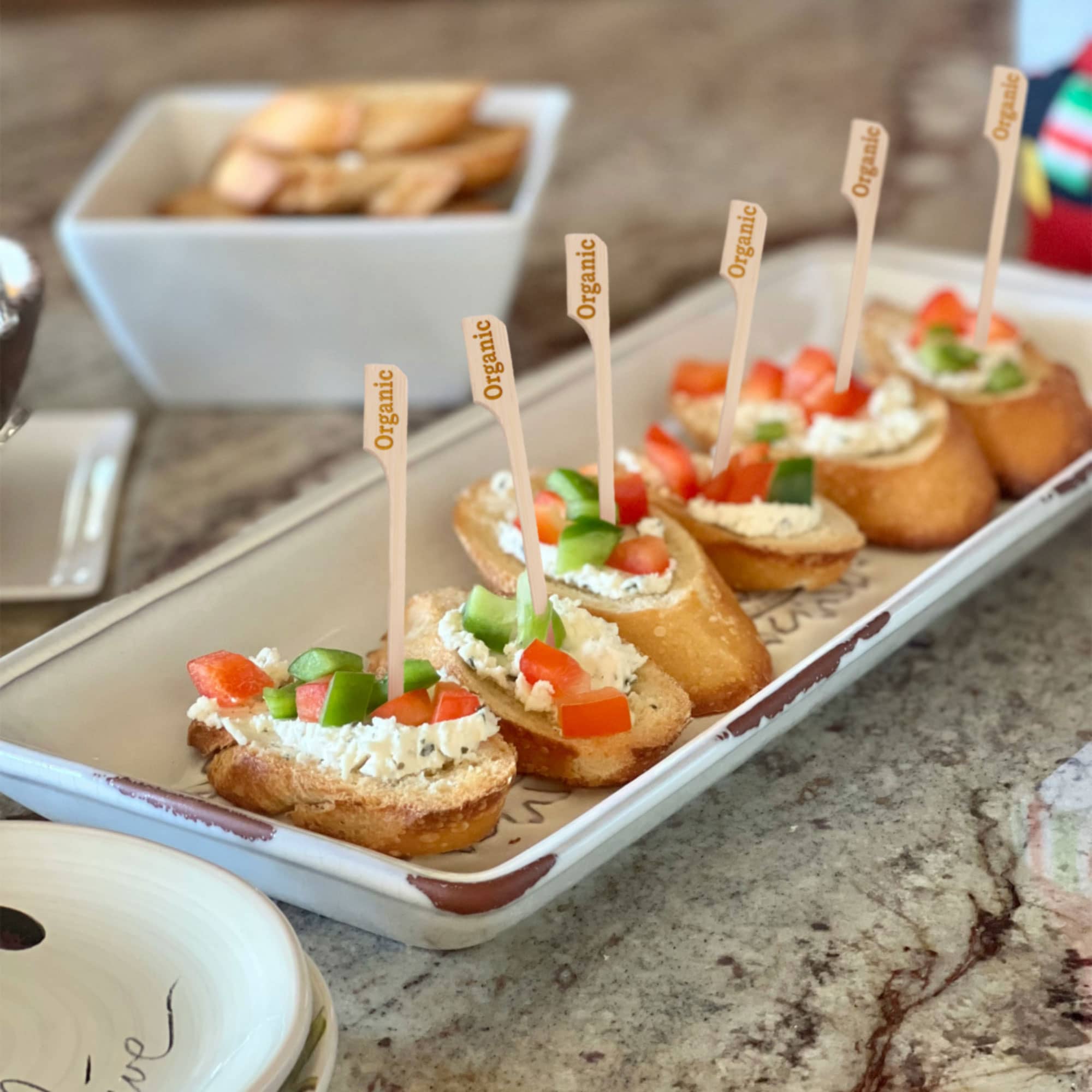 organic label bamboo paddle picks skewers food drink cocktail appetizer dessert white bread cream peppers platter spread catering