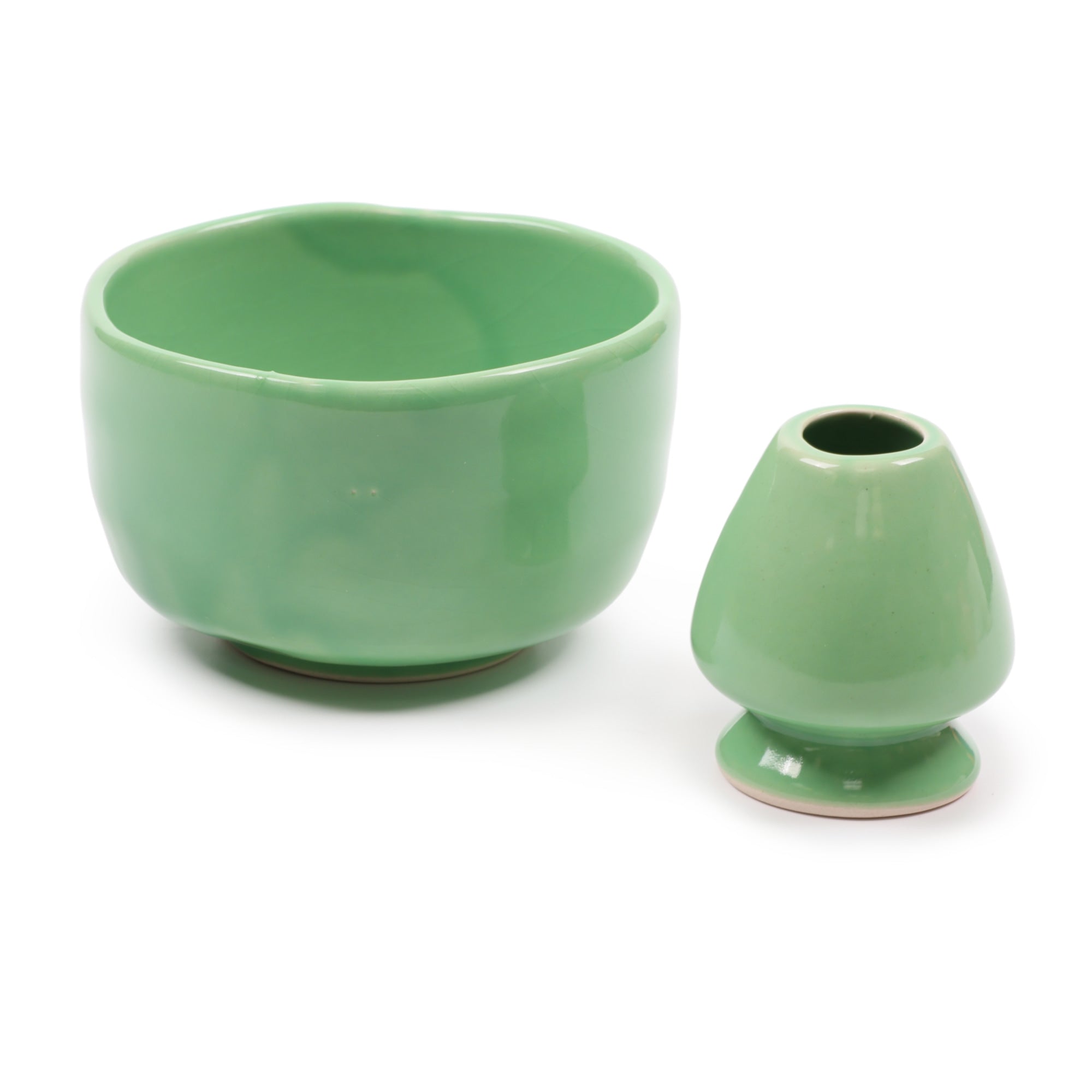 Two green ceramic items on a white background