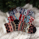3 socks of the same pattern but different color laying on blanket
