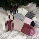 3 socks of the same pattern but different color laying on blanket