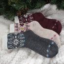 3 socks of the same pattern but different color laying on blanket