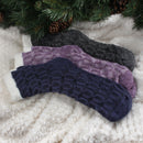 3 socks of the same pattern but different color laying on blanket