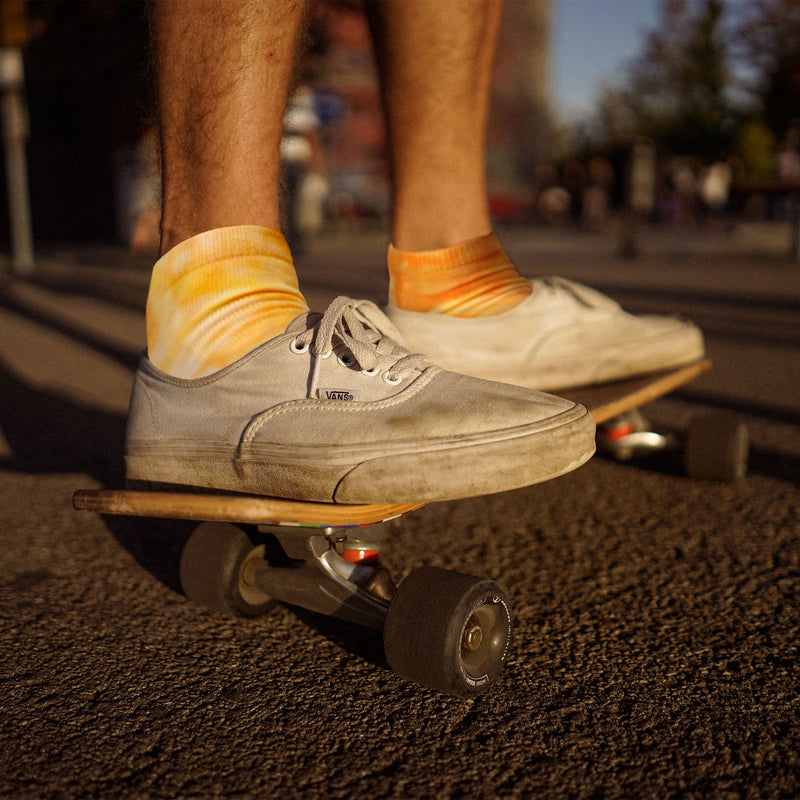 Person skateboarding with tie dye socks on
