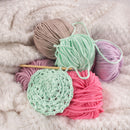 yarn clustered together with knitting needle