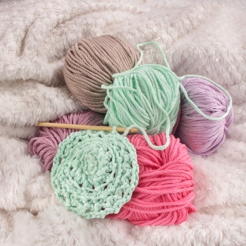 yarn clustered together with knitting needle