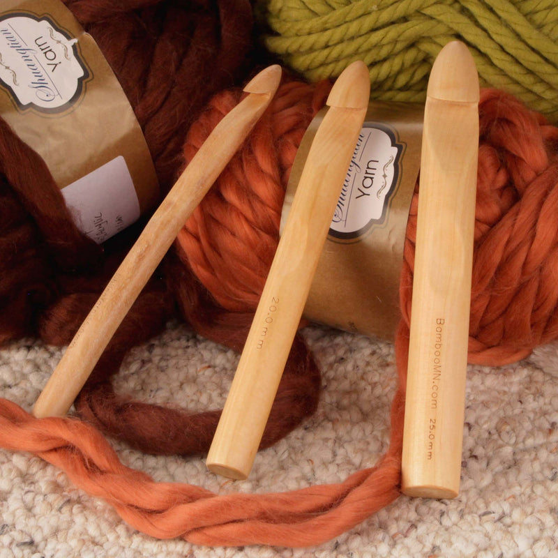 three crochet hooks on yarn