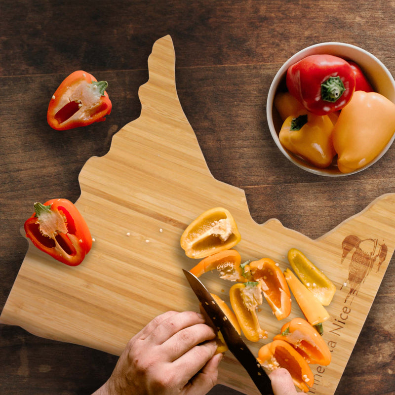 Minnesota Nice with Loon Engraved Cutting and serving board lifestyle image with bell peppers