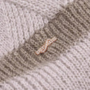 close up of cute charm detail on beanie
