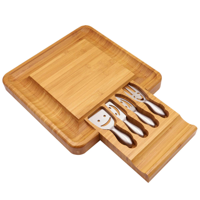 Angled top view of bamboo cheese board with stainless steel utensils for serving