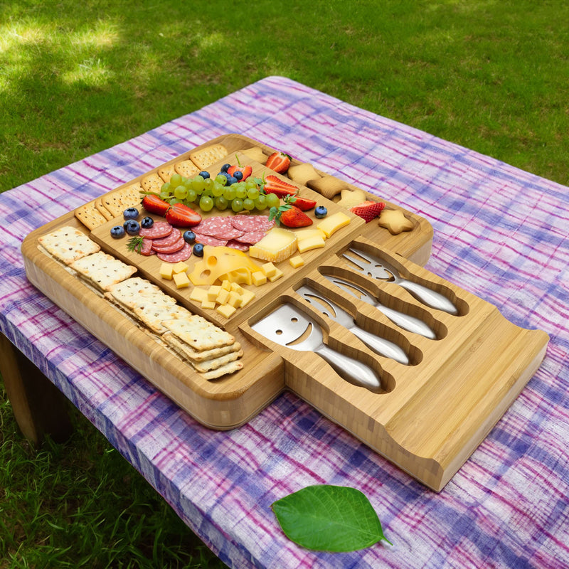 Cheese board on picnic table with snacks