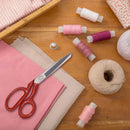 red grooved fabric scissors