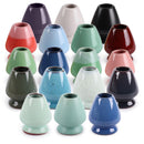 A collection of ceramic matcha tea whisk holders in various colors including black, blue, green, pink, purple, red, white, brown, verdigris, temmoku, light mist, green floral, matte green, light aqua, medium blue