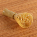 plastic matcha tea whisk wood background