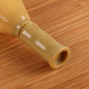 plastic matcha tea whisk handle wood background