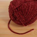 Red yarn thread skein pull 