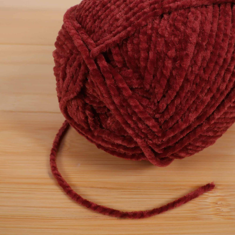 Red yarn thread skein pull 