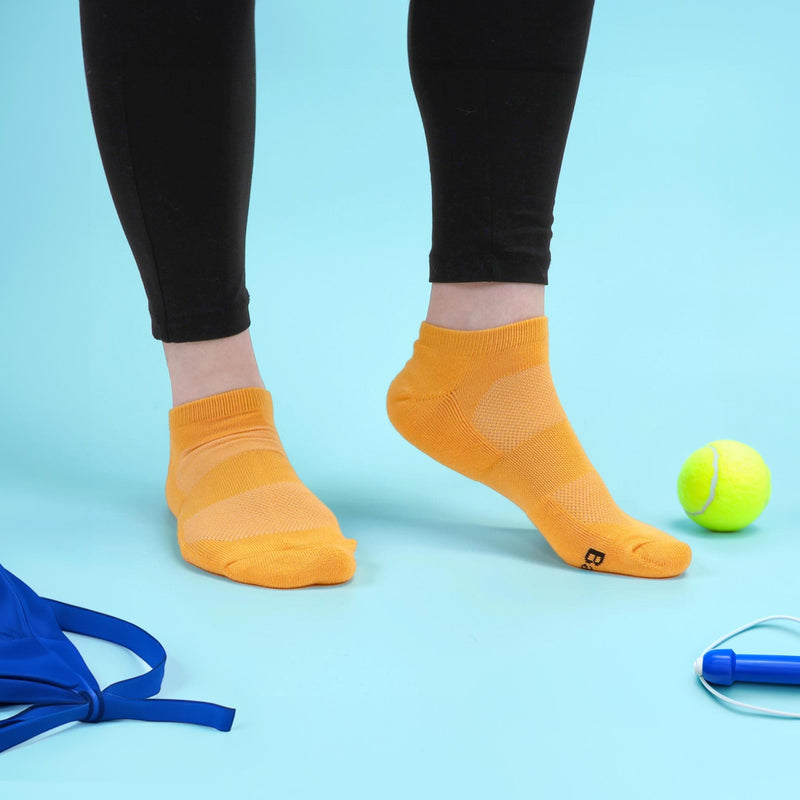 Orange running socks for exercise shown