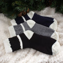 3 socks of the same pattern but different color laying on blanket