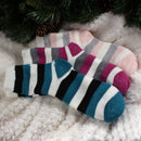 3 socks of the same pattern but different color laying on blanket