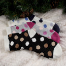 3 socks of the same pattern but different color laying on blanket