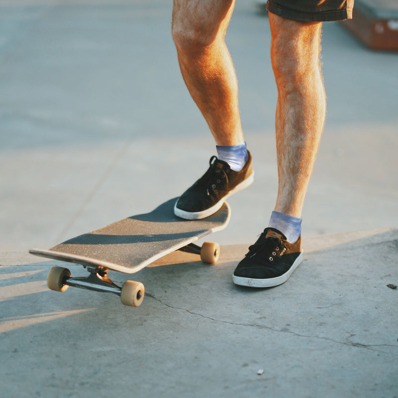 Person skateboarding with tie dye socks on