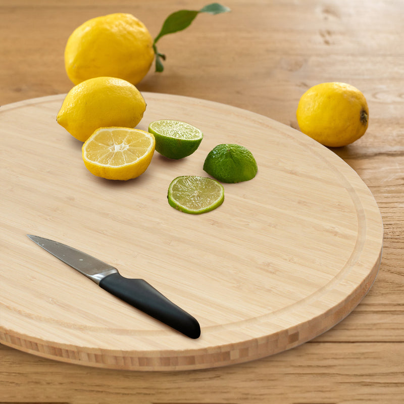 bamboo grooved oval cutting and serving board life style cutting lemon and limes