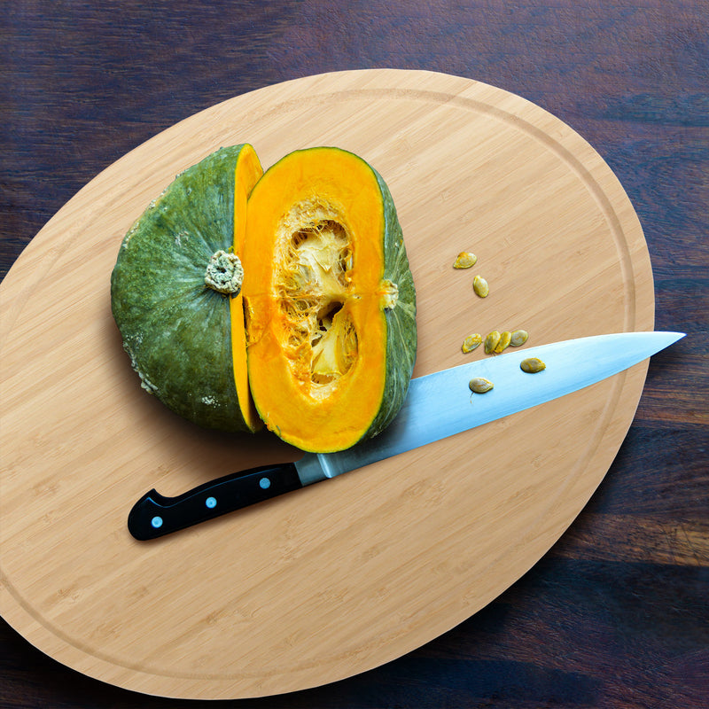 bamboo grooved oval cutting and serving board lifestyle cutting fruits