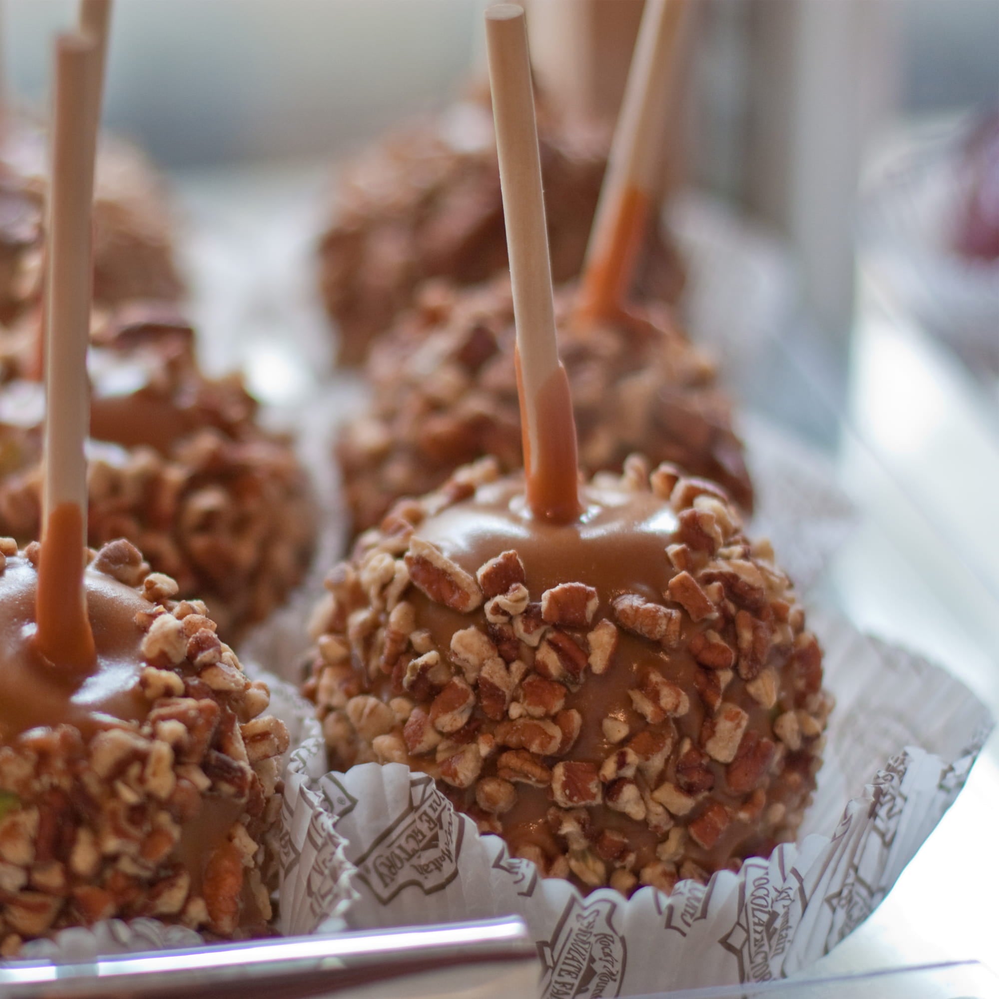 bamboo food skewer caramel apple with crushed nuts