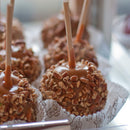 bamboo food skewer caramel apple with crushed nuts