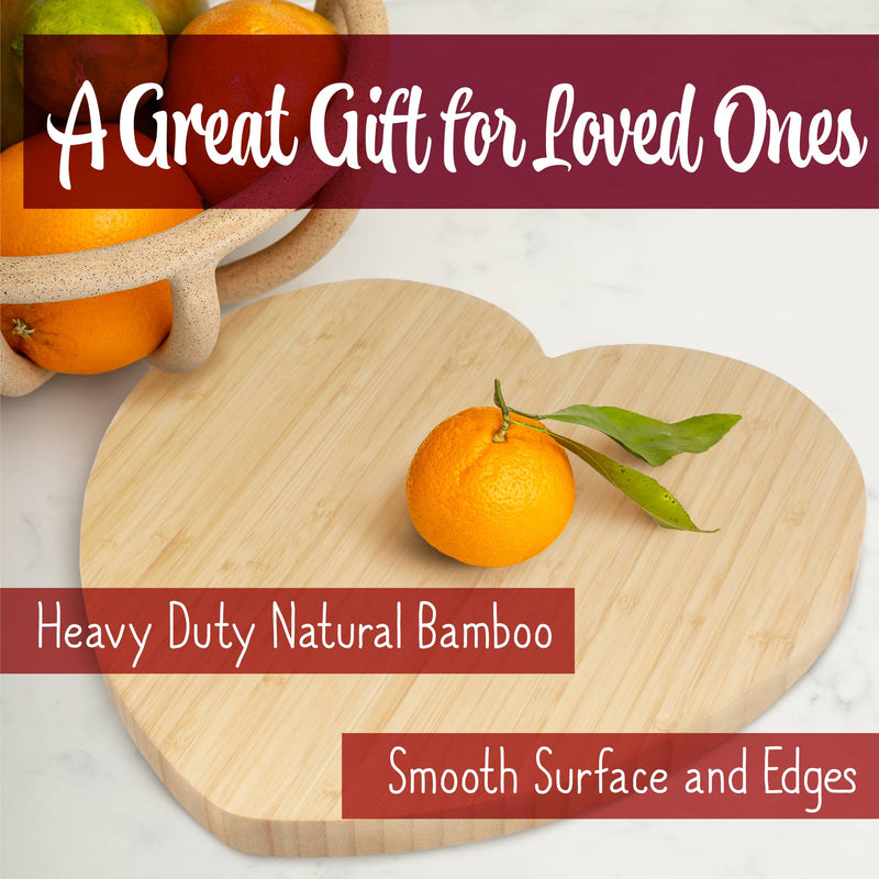 Heart shaped bamboo cutting board with an orange on it