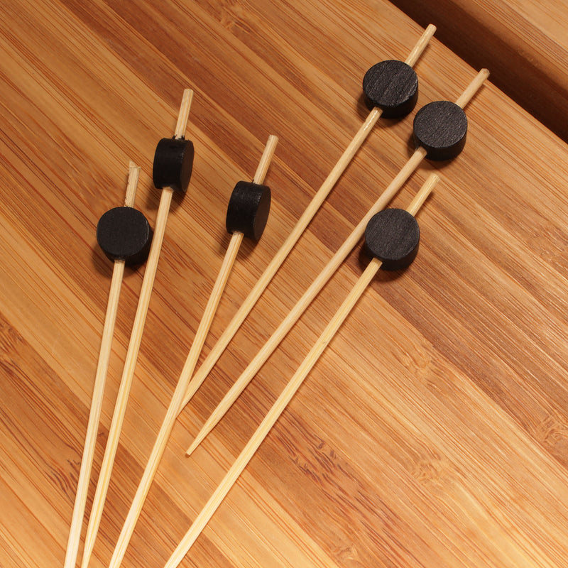 black circle picks on bamboo board