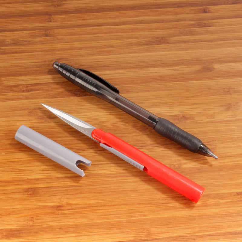 small scissor in comparison to pen