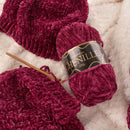 majenta yarn with knitting needle and hat made from the same yarn
