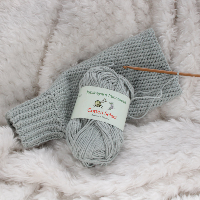 grey yarn with knitting needle