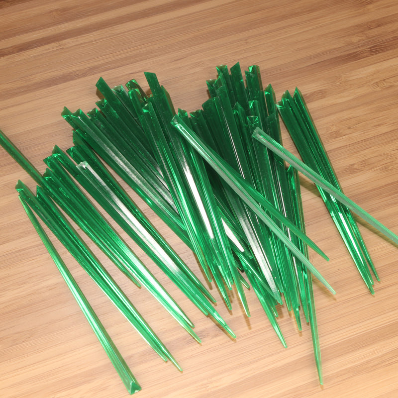 3.5" dark green prism plastic skewer picks on bamboo wood