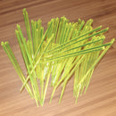 3.5" lime green prism plastic skewer picks on bamboo wood