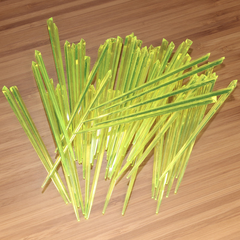 3.5" lime green prism plastic skewer picks on bamboo wood