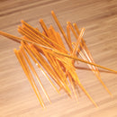 3.5" orange prism plastic skewer picks on bamboo wood