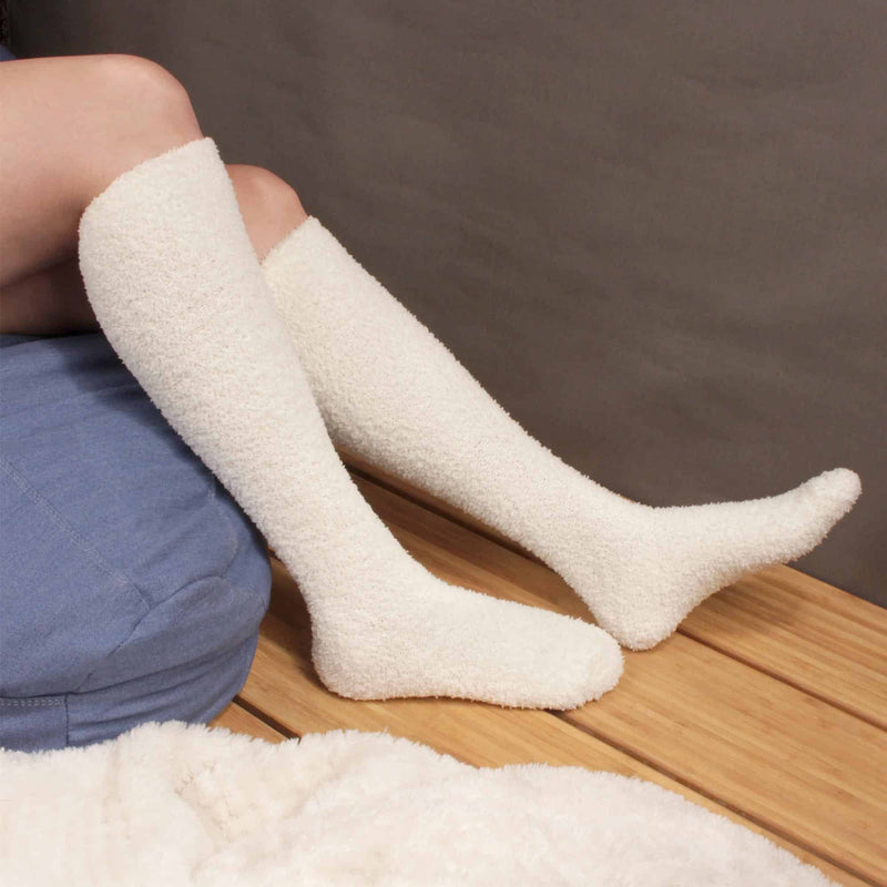 Slip on a pair of our most popular white fuzzy knee high socks