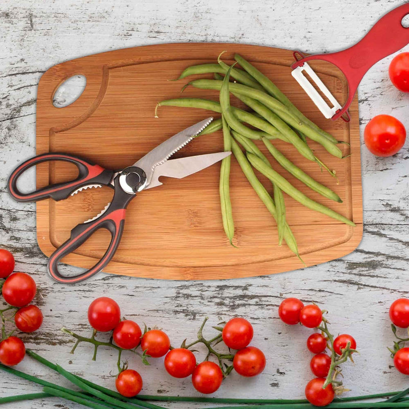 scissors and peeler on a cutting board