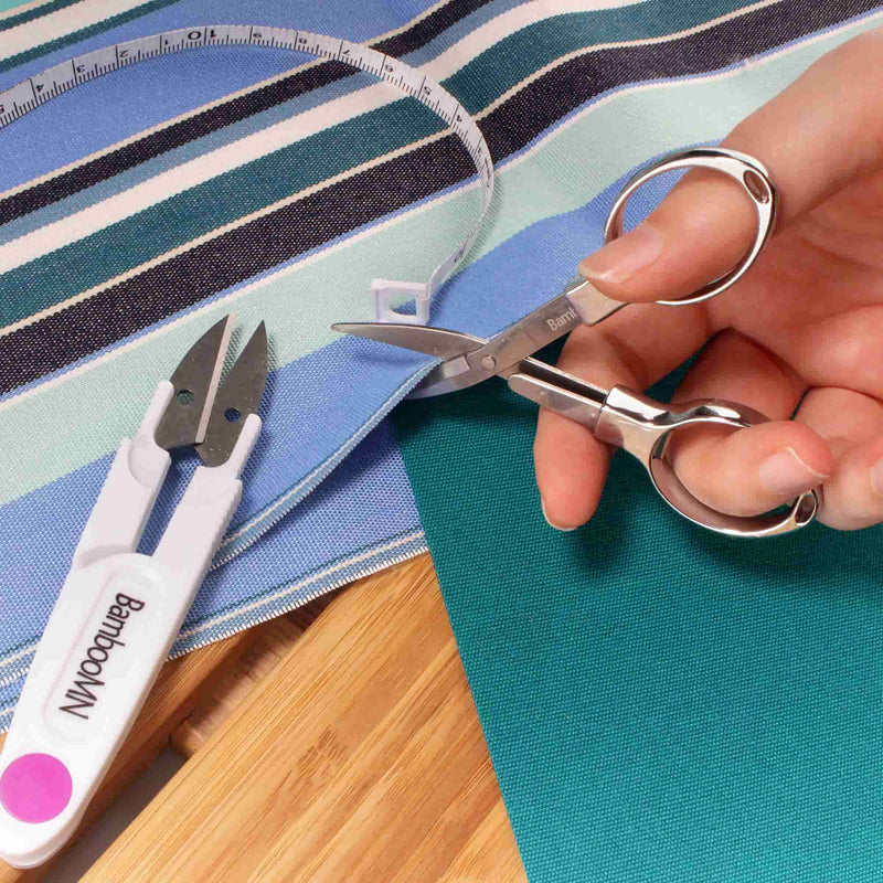 folding scissors cutting fabric