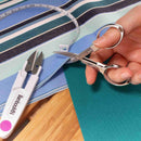 folding scissors cutting fabric