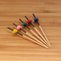 small bamboo ball picks assorted colors on bamboo surface