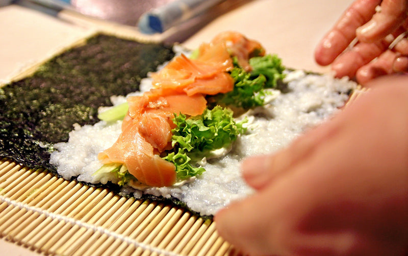 sushi on bamboo rolling mat